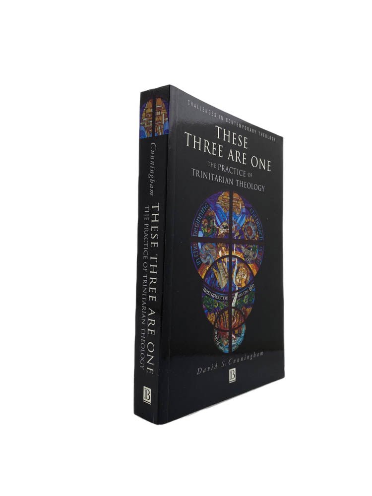 Cunningham, David S - These Three are One : The Practice of Trinitarian Theology | front of book. Published by Blackwell in 1998. Paperback.  Condition:  Near Fine/No Jacket ( as Issued )