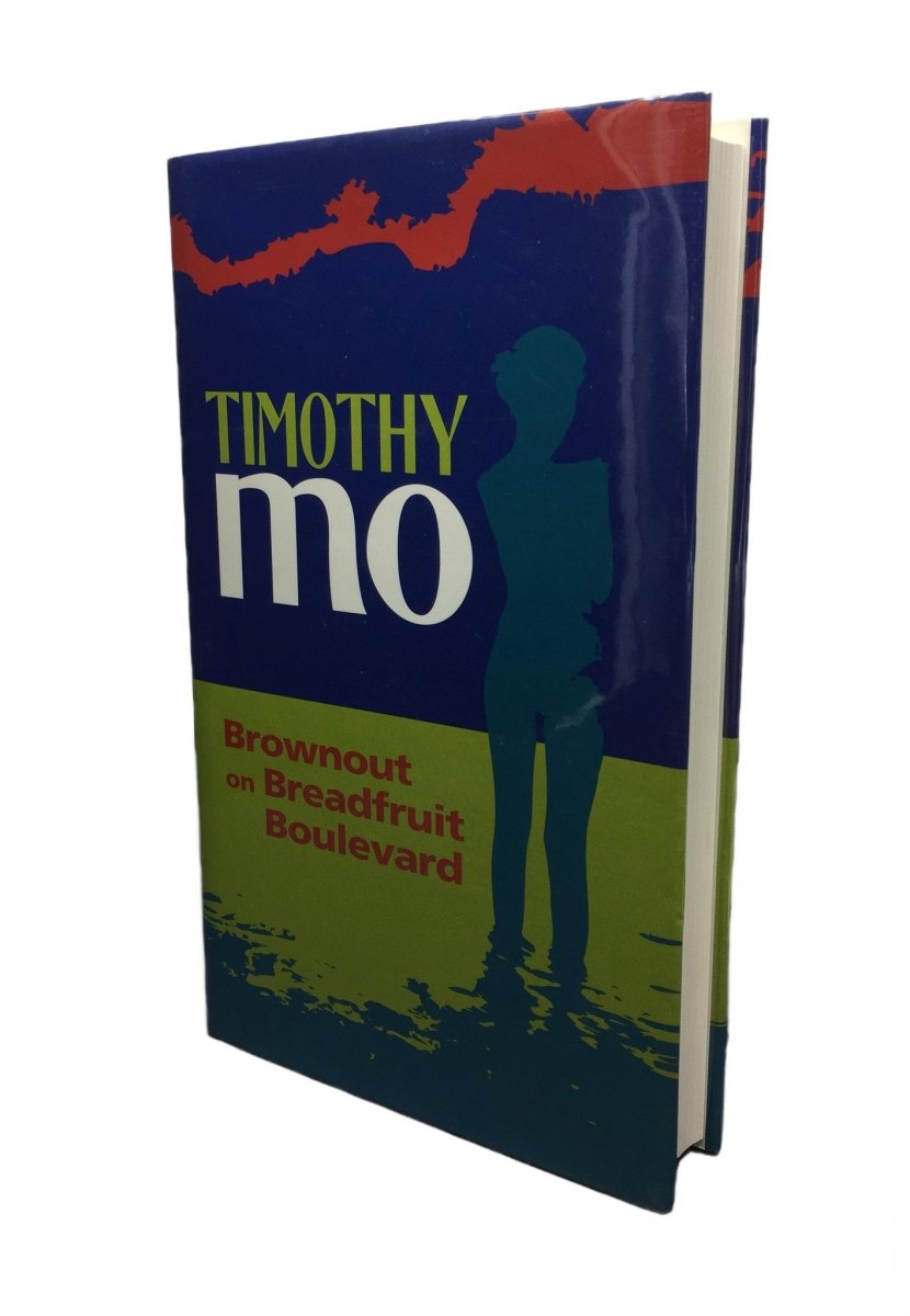 Mo, Timothy - Brownout on Breadfruit Boulevard | front cover. Published by Paddleless in 1995. Hardcover.  Condition:  Fine/Fine