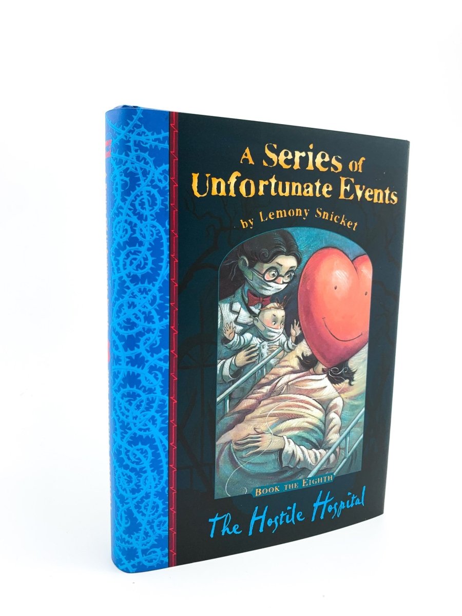Snicket, Lemony - The Hostile Hospital - with the reversible wrapper | front cover. Published by Egmont in 2003. Hardcover.  Condition:  Near Fine/Fine