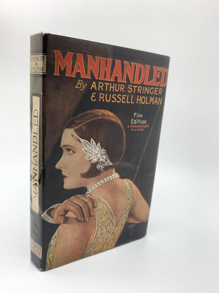 Stringer, Arthur - Manhandled ( Film Edition ) | front cover. Published by Readers Library in 1925. Hardcover.  Condition:  Very Good +/Very Good++ / Near Fine